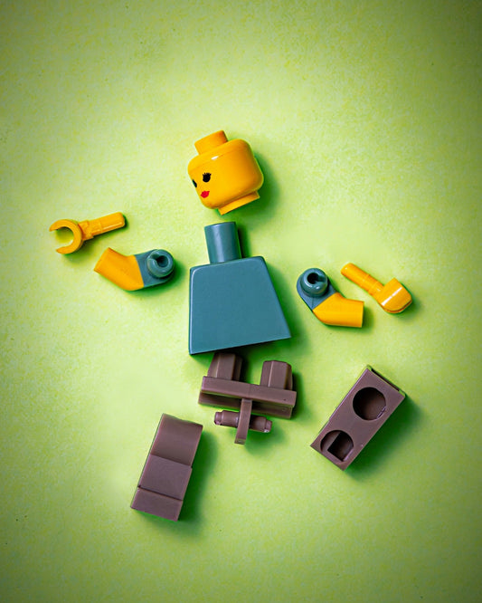 Broken lego representing CEO pulled in too many directions and needing an executor